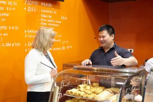 The Victorian Small Business Commissioner, MS Judy O'Connell, speaking with a small business owner at his bakery cafe.