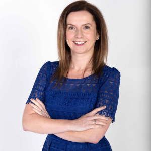 Commissioner Lynda McAlary-Smith smiling with her arms crossed