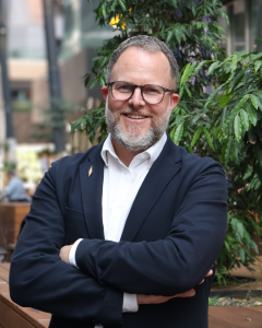 Tim Symonds smiling with crossed arms